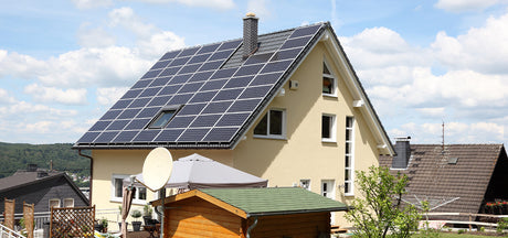 A house with solar panels on the roof. Save money with solar energy from Rich Solar.