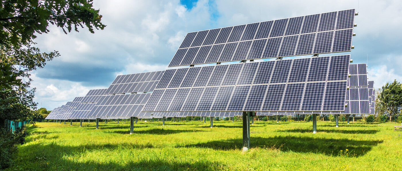 Solar panels on a field, harnessing clean energy from the sun to reduce carbon footprint and protect the environment.