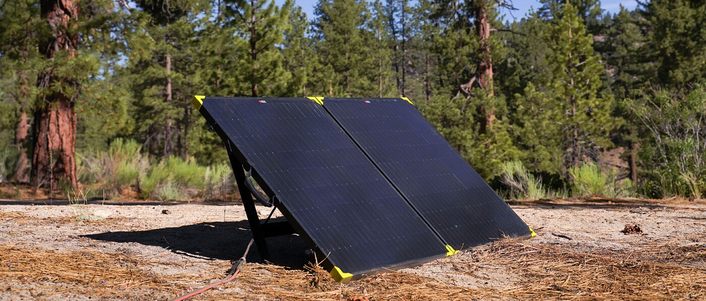 A man relaxes atop a vehicle equipped with a tent, showcasing a perfect setup for solar-powered camping adventures.